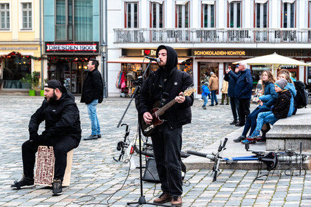 Dresden, Germany, December 24, 2023: Street musicians perform in the square at the Martin Luther...