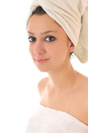 beauty halth and spa wellness isolated young woman face portrait closeup with towel and flower treatmentの写真素材