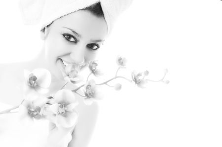 beauty halth and spa wellness isolated young woman face portrait closeup with towel and flower treatmentの写真素材