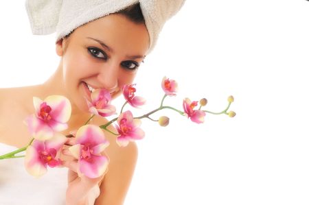 beauty halth and spa wellness isolated young woman face portrait closeup with towel and flower treatmentの写真素材