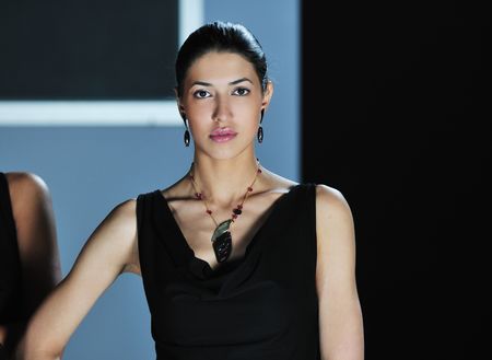 beautiful woman on fashion show piste with gold jawelの写真素材