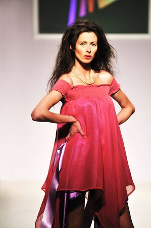 young beautiful model walking on fashion show pisteの写真素材
