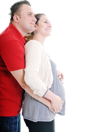 young family couple together in studio isolated on white. happy and waiting for babyの写真素材