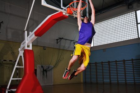 one healthy young  man play basketball game in school gym indoor