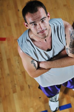 one basket ball game player standing in sport gym with ballの写真素材