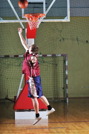 one healthy young  man play basketball game in school gym indoorの写真素材