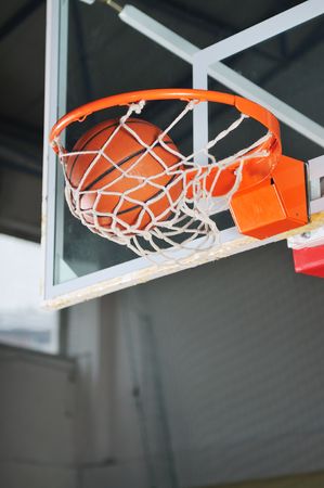 oreange basket ball in basketball basketの写真素材