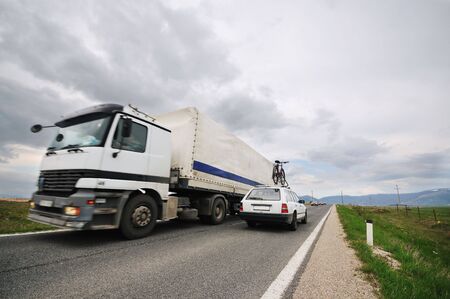 big truck drive on long country roadの写真素材