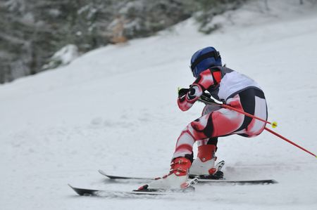 young skier race fast downhil at winter snow scene の写真素材