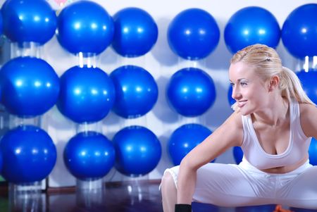 pretty blonde girl working out in fitness clubの写真素材