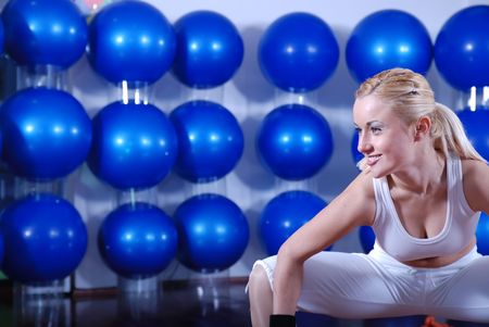 pretty blonde girl working out in fitness clubの写真素材