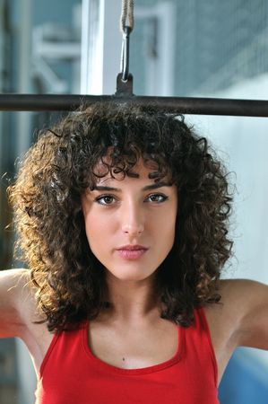 young woman practicing fitness and working out in a gym の写真素材