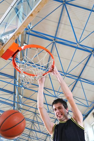 one healthy young  man play basketball game in school gym indoorの写真素材