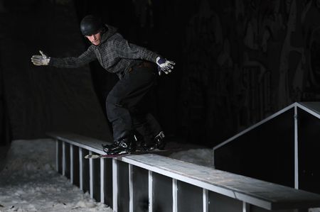 young free style snowboarder jumping in air and make acrobations