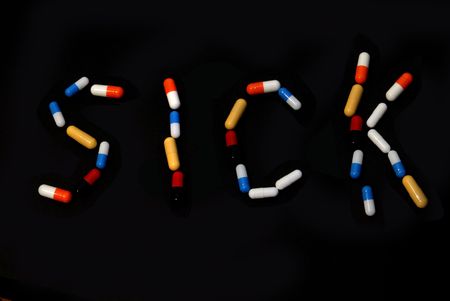 word 'sick' writen with pils on black background                   の写真素材