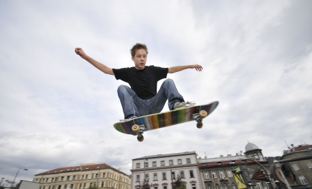 Boy practicing skate in a skate parkの写真素材
