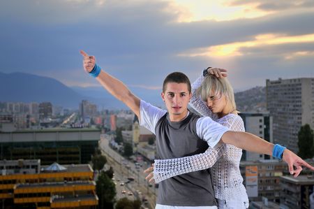 romantic urban couple dancing on top of the buldingの写真素材