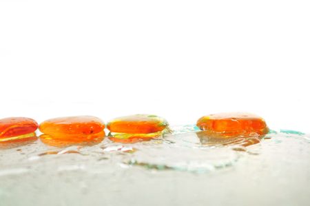isolated wet zen stones with splashing  water drops  representing concept of natural balance and perfect harmonyの写真素材
