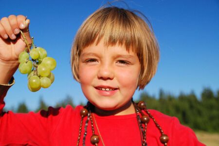 happy girl withy grape outsideの写真素材