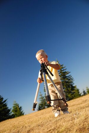 little boy with tripod の写真素材