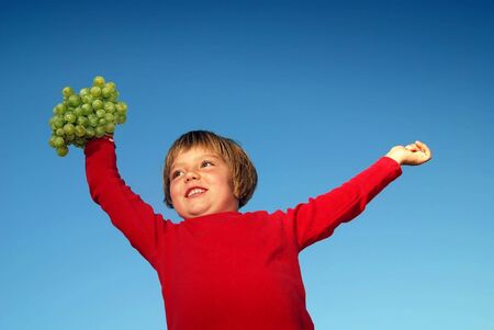 girl with grape outdoor