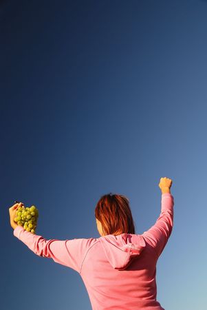 girl with grape outdoorの写真素材