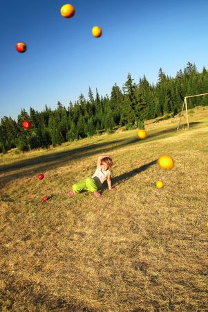 young happy girl throwing apple の写真素材