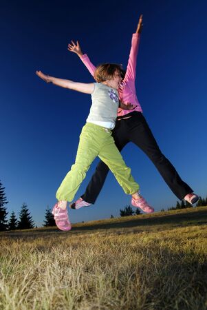 happy girls Jumping in to airの写真素材