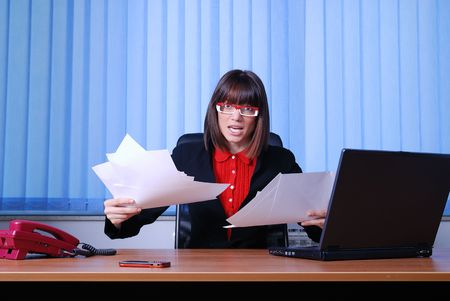 happy business woman throw documents and papers in officeの写真素材
