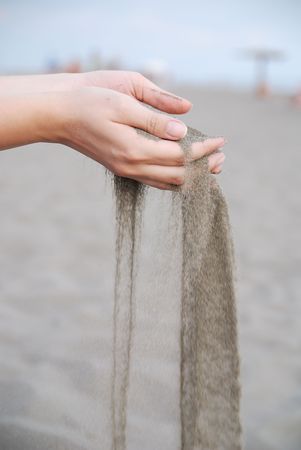 fine sand leaking trought woman handsの写真素材