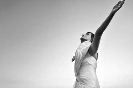 happy young beautiful bride after wedding ceremony event have fun on meadow in fashionable wedding dressの写真素材