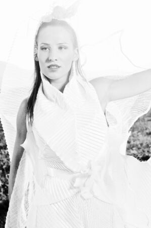 happy young beautiful bride after wedding ceremony event have fun on meadow in fashionable wedding dressの写真素材