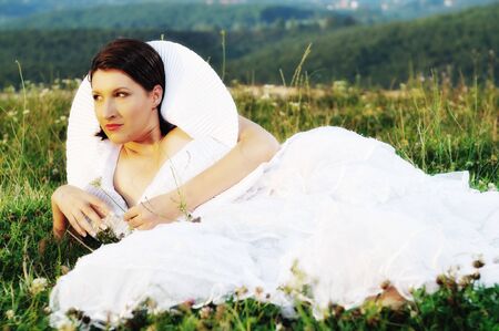 happy young beautiful bride after wedding ceremony event have fun on meadow in fashionable wedding dressの写真素材