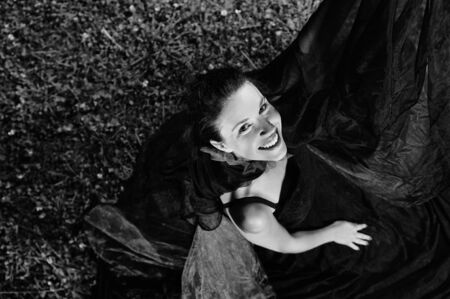 young beautiful bride in black wedding dress in dar at night の写真素材