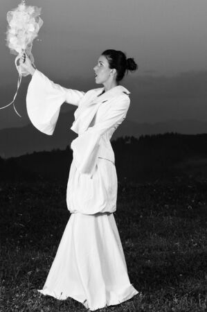 happy young beautiful bride after wedding ceremony event have fun on meadow in fashionable wedding dressの写真素材