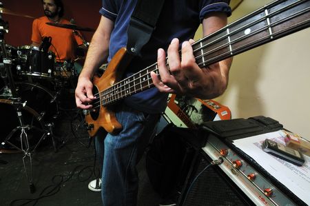 young music player and band friends have training in home garage