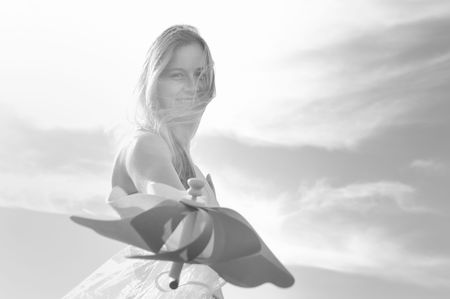 happy young beautiful bride after wedding ceremony event have fun outdoor on meadow at sunset with windmill toy and representing smart energy の写真素材