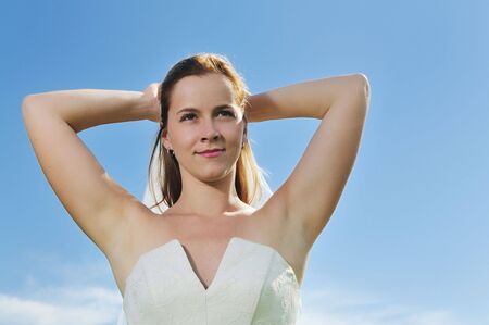 happy young beautiful bride after wedding ceremony event have fun outdoor on meadow at sunsetの写真素材