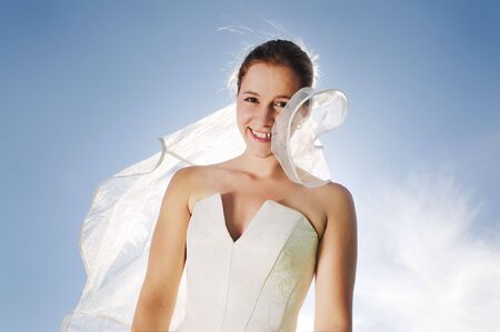 happy young beautiful bride after wedding ceremony event have fun outdoor on meadow at sunset