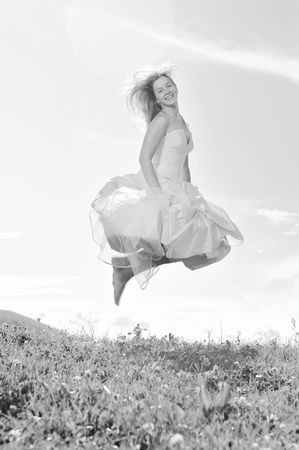 happy young beautiful bride after wedding ceremony event have fun outdoor on meadow at sunsetの写真素材