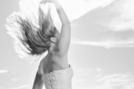 happy young beautiful bride after wedding ceremony event have fun outdoor on meadow at sunsetの写真素材