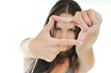 young beautiful woman gesturing frame and perspective concept fith hands isolated on whiteの写真素材