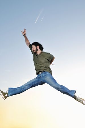 young man jumping in air at sunset outdoor