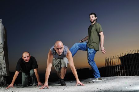 three young man in start position ready to race and runの写真素材
