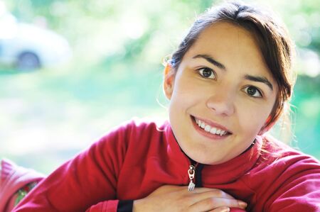 happy young beautiful woman face portrait outdoor in naturaの写真素材