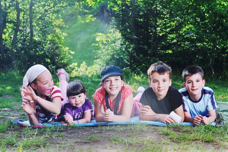 happy children group  have fun outdoor in nature at suny dayの写真素材
