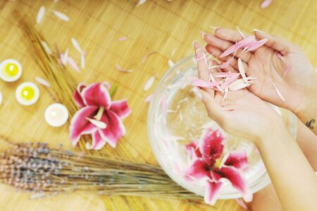 hand spa and beauty treatment with aroma and flowers in waterの写真素材