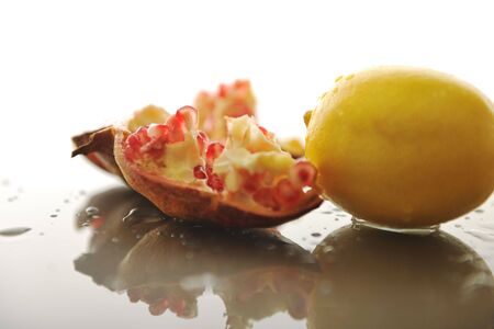 fresh and healthy fruit food lemon and Pomegranate isolated on whiteの写真素材