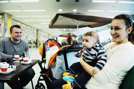 happy young family in shopping centre indoor 