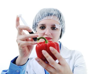 isolated on white young nurse doctor woman with red vegetable food papper representing bio food concept の写真素材